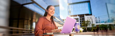 Female online certificate program student completing work online outside