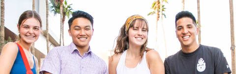 Male and female minors degree students smiling outside on GCU's campus