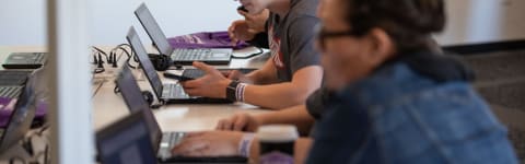 Students Working at Laptop