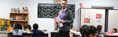 a teaching alumni in the classroom with his students