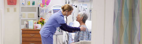 a nurse helping an elderly patient at a hospital