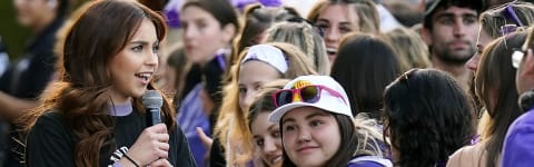 a student hypes up a crowd on campus