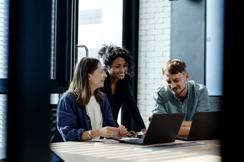 people surrounding computer at work