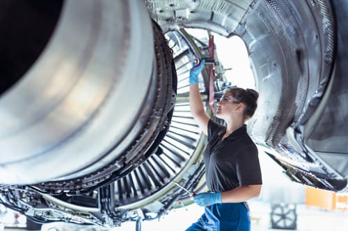 woman engineer examining an airplane wing