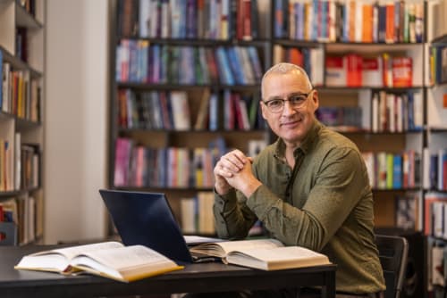 Male doctoral student studying in library