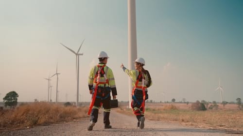 Two engineers checking out windmills.