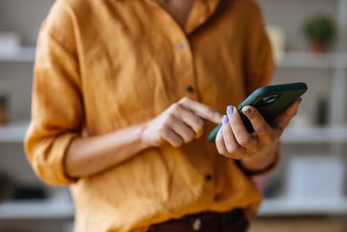 a woman using her phone indoors