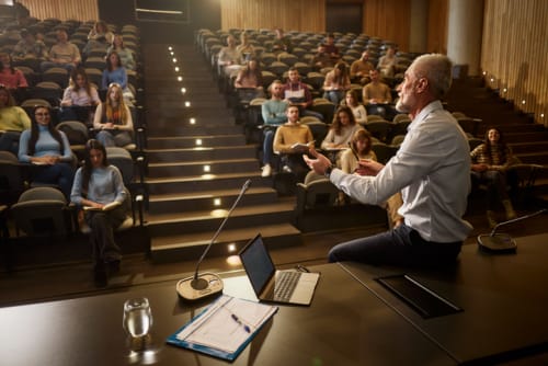 Mature professor lecturing college class