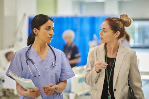 Two colleagues discuss hospital affairs.