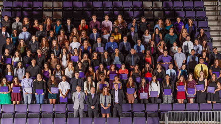 Large group of students pose for picture in GCU Arena