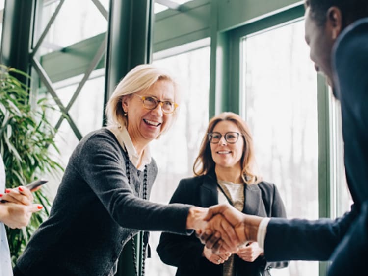 woman and man shaking hands