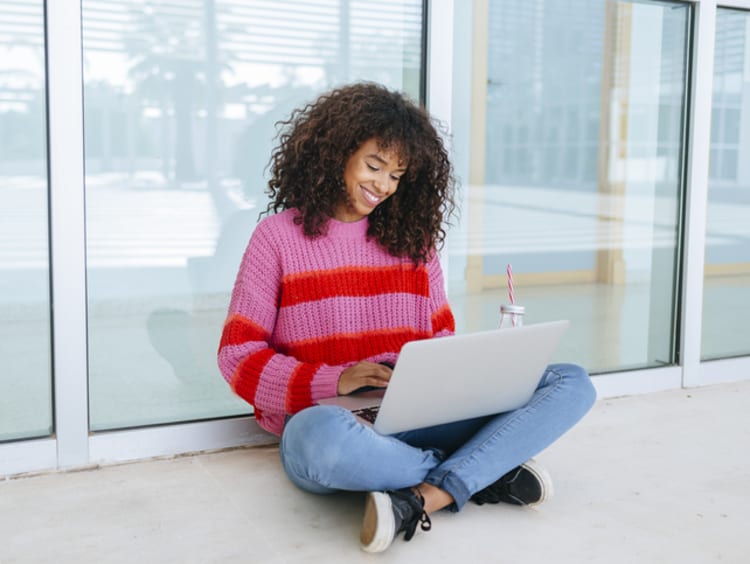 college student working on her online class outside