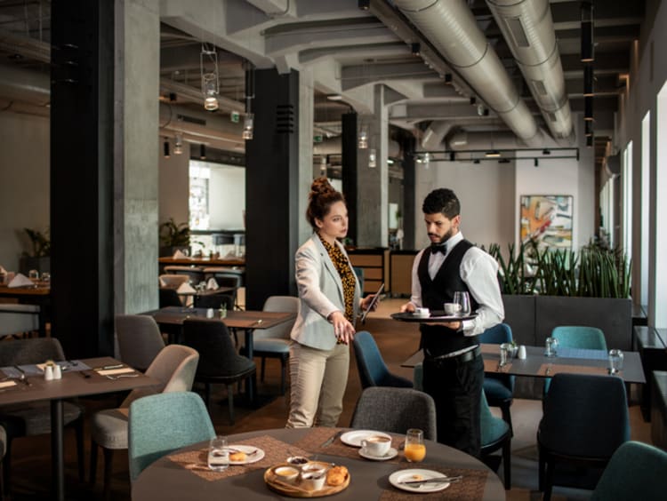 Restaurant manager talking to staff