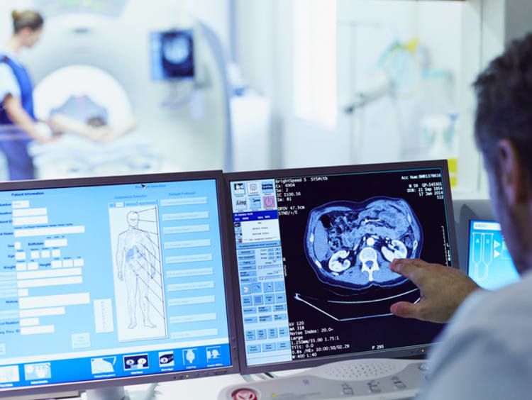 Doctor working with health informatics on desktops