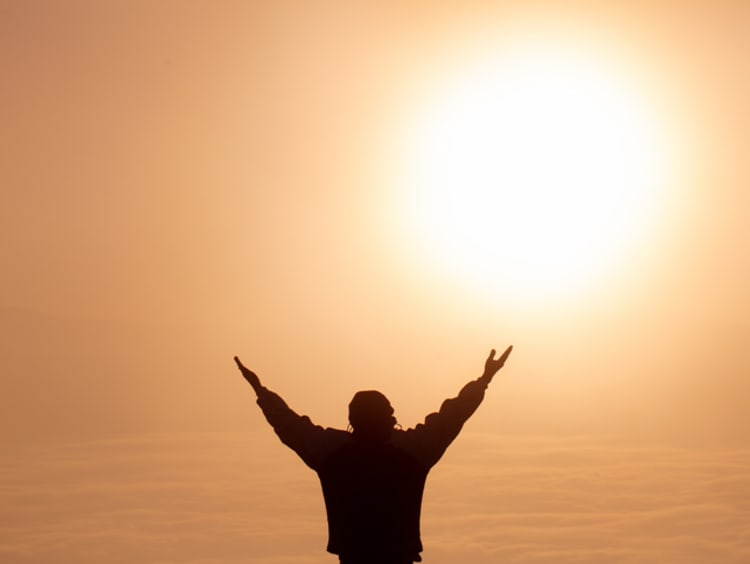Person raising arms in worship