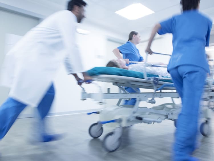 ER nurses and doctor with patient on stretcher