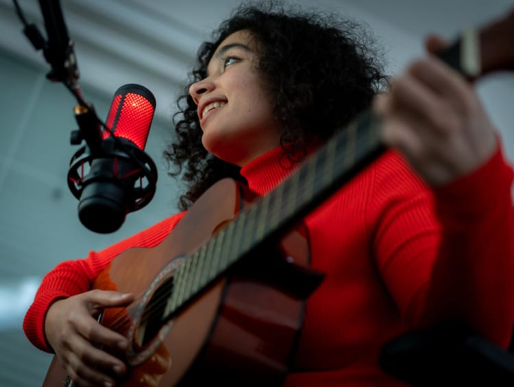 Young woman recording music