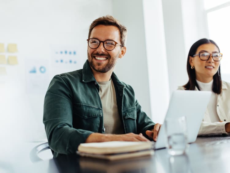 A man and woman working and smiling