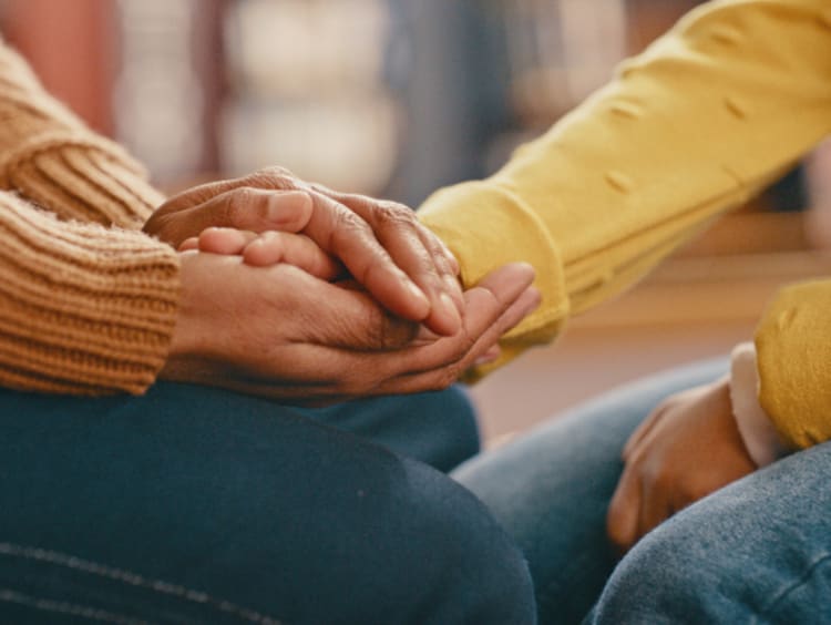 People holding hands in support