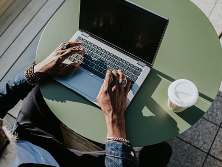 Man working on computer with coffee