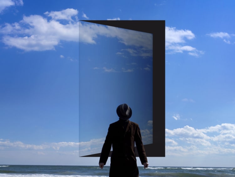 Man stands in front of the opened door in the sky. - stock photo