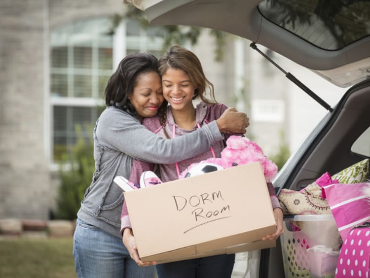 Mother hugging daughter goodbye as she moves into a dorm