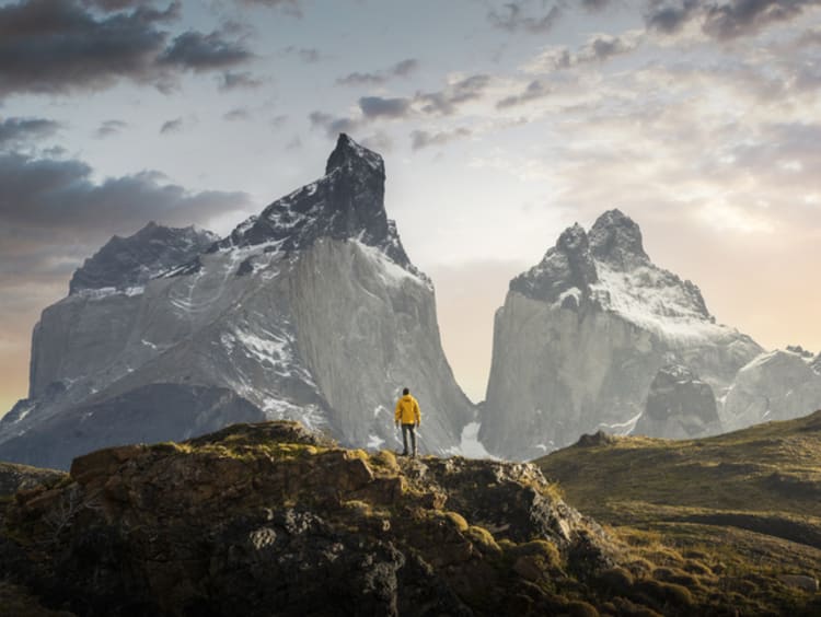 Hiker admiring the Cuernos del Paine range, Patagonia - stock photo