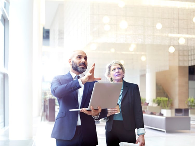 Two people discussing business strategies.