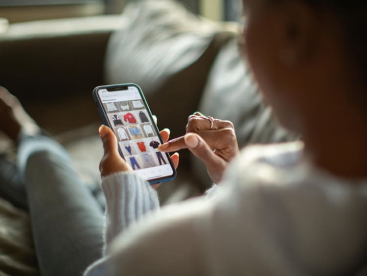 Woman scrolling and looking at clothes on phone