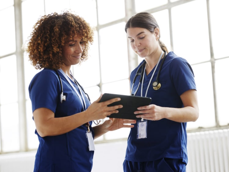 two female nurses meeting and working together