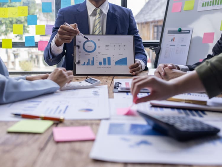 Accountants working together analyzing graphs and charts