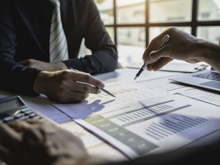Business professionals analyzing graphs and charts together
