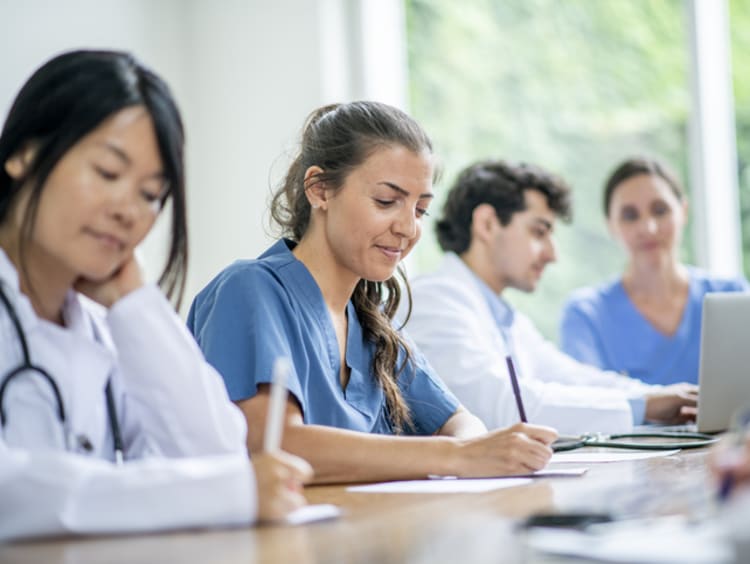Doctors learning and working together - stock photo