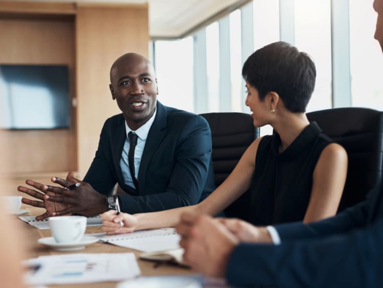 A CEO speaking and managing a office meeting