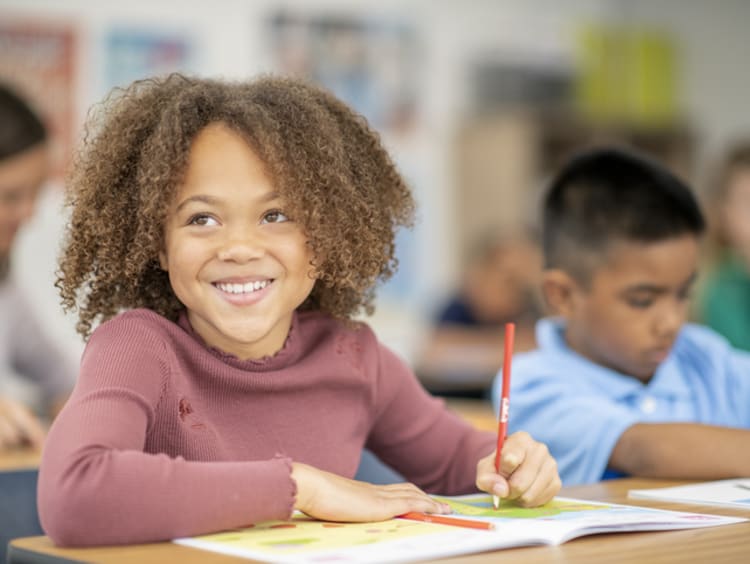 Elementary student drawing in classroom