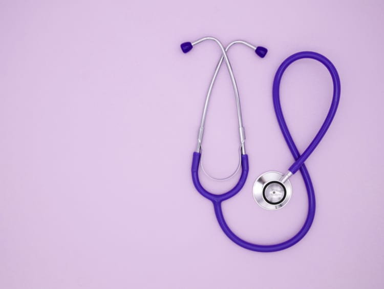 Stethoscope on a pink background with copy space. Medical flat lay. Color of year 2022 Very peri. - stock photo