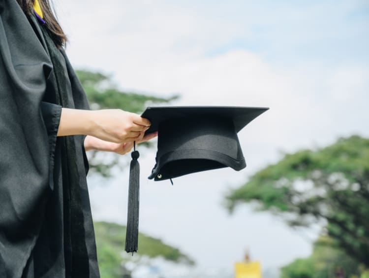student wearing graduation cap and gown