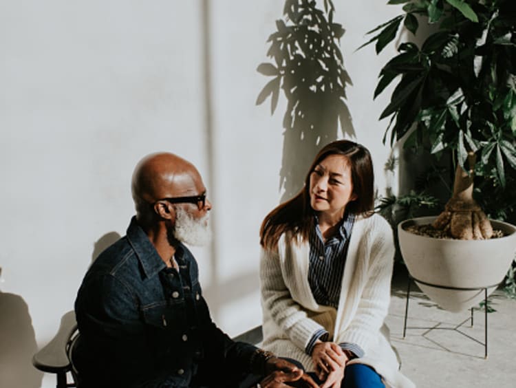 Woman patiently talking with an old man.