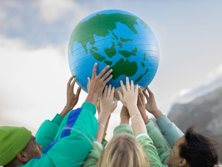 Group of teenagers holding up the world - stock photo
