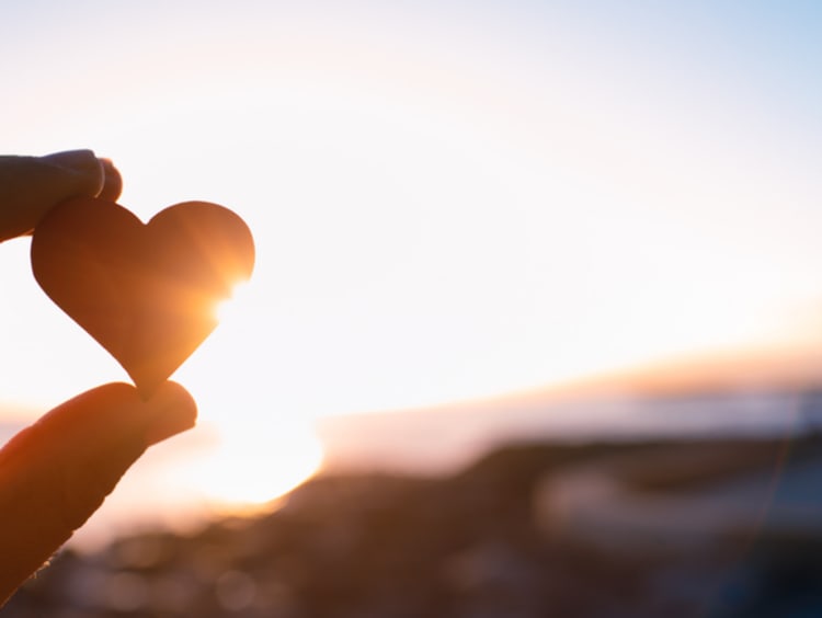 Hand holding here in the sunset. I love nature concept - stock photo