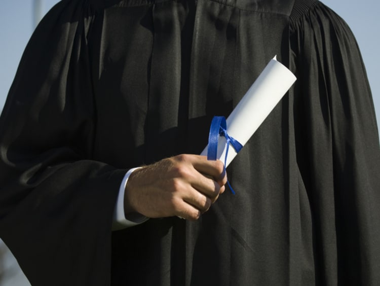 Graduate holding diploma