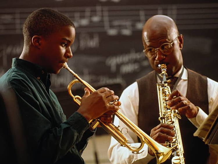 Student and Teacher making music together.