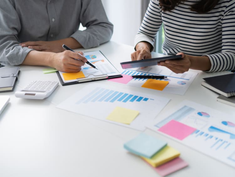 policy analysts working on desk with charts
