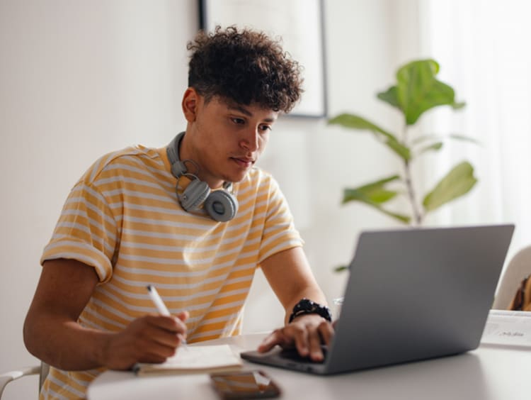 Young man works on his computer.