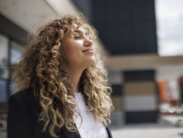 A woman taking in a breath.