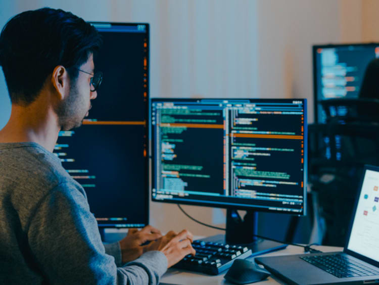 Two people working on computer science vs cybersecurity networks