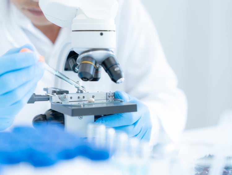 Scientist using a microscope for medical research