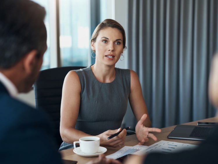 Woman speaks with her coworkers.
