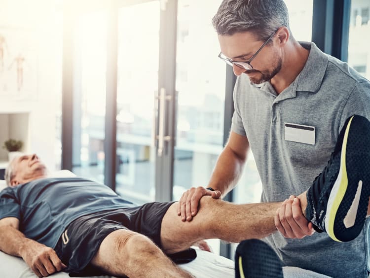 Physical Therapist helping elderly patient