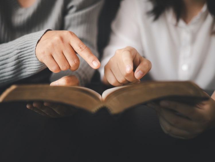 In the church, people to read Bible together, strengthening their faith as devout Catholics united by teachings of holy book. Christians are congregants join hands to pray and seek blessings of God. - stock photo